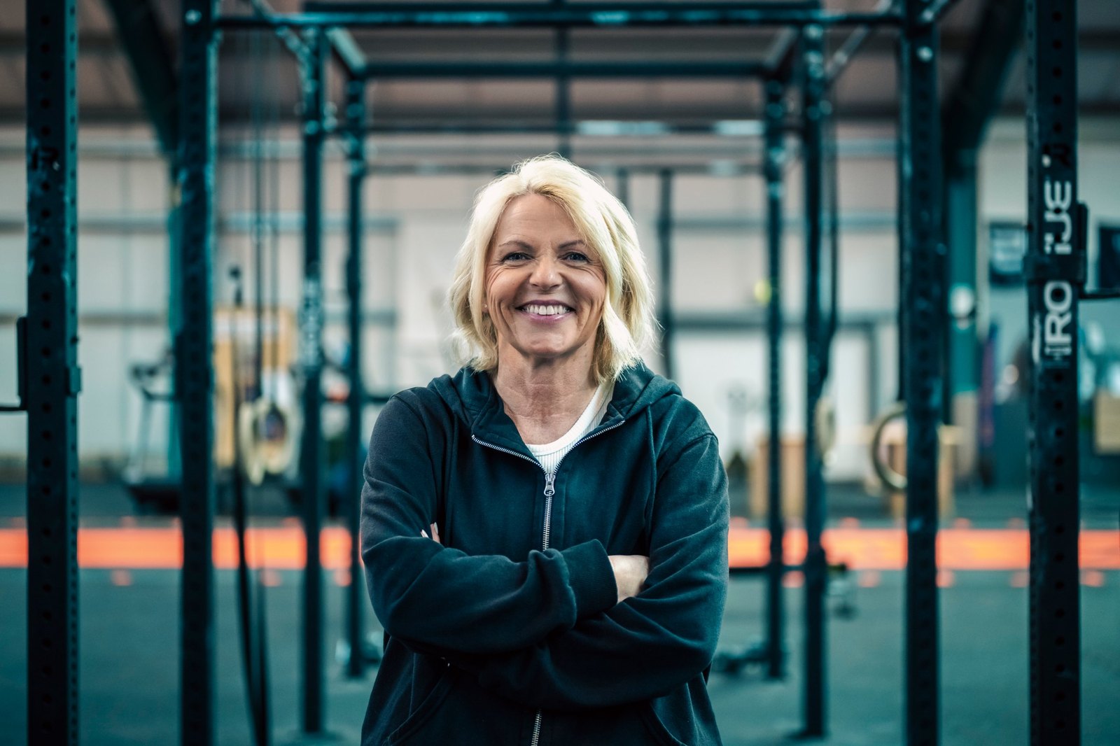 Anja Lorenz im Trainingsraum, lachend mit verschränkten Armen
